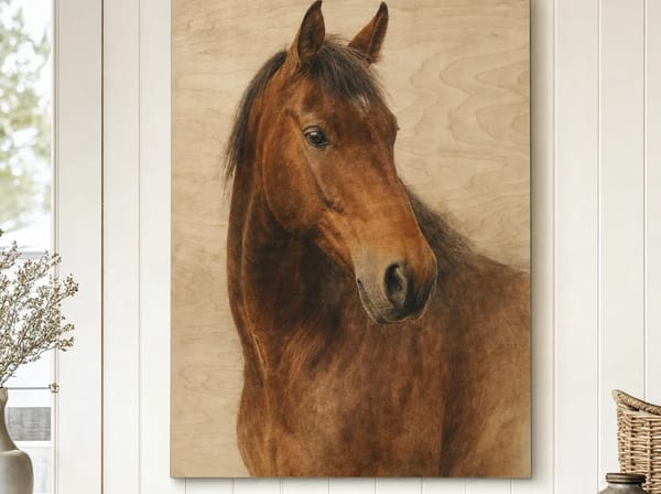 A natural plywood wood print portrait of a bay horse, three-quarter angle head-and-shoulders, on a country living-room wall, the wood grain showing softly through the lighter tones.