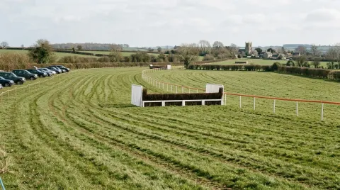 A birch fence and running rail on a point-to-point course laid out across open farmland.